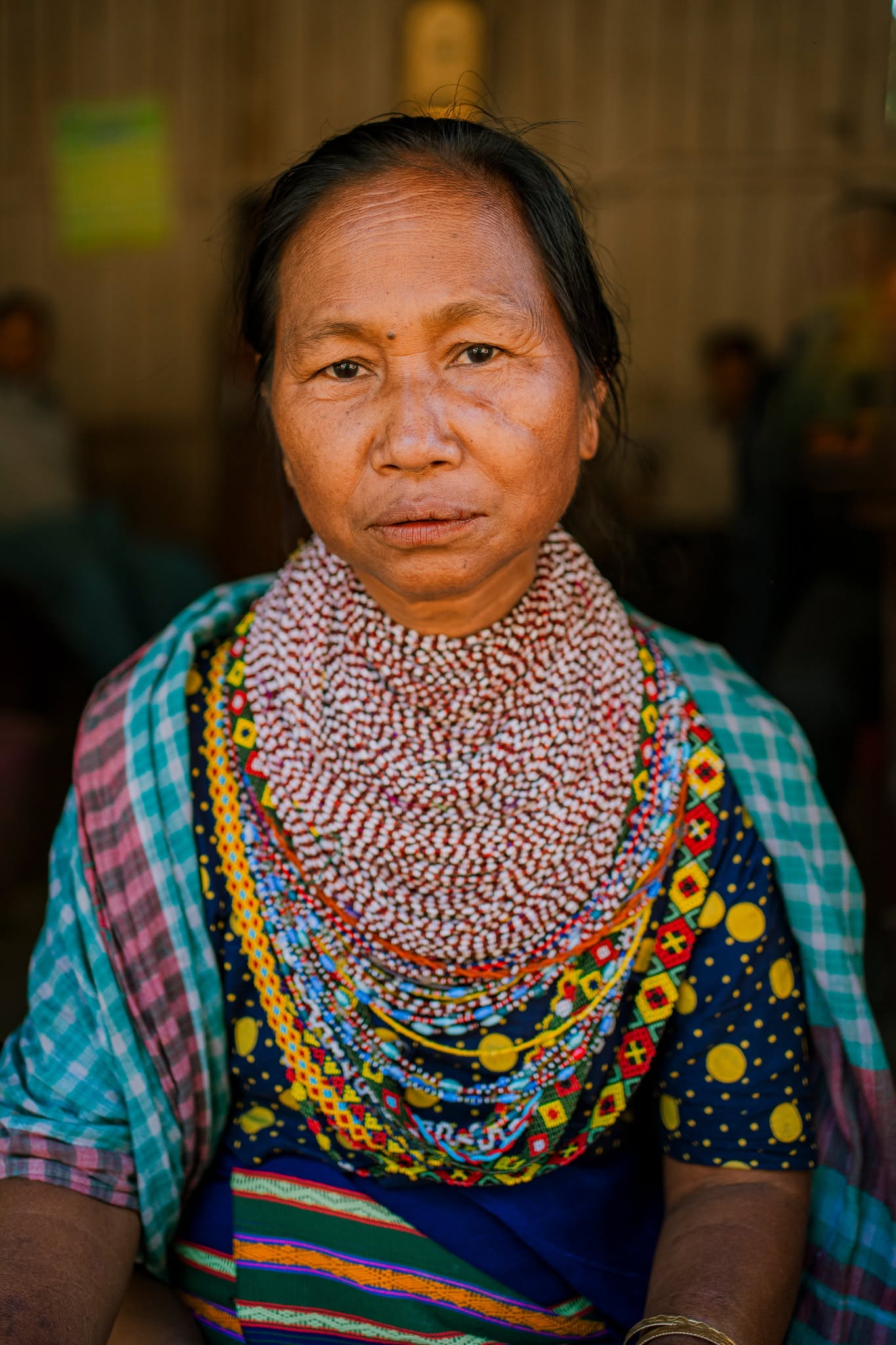 Elderly indigenous woman in traditional beaded attire