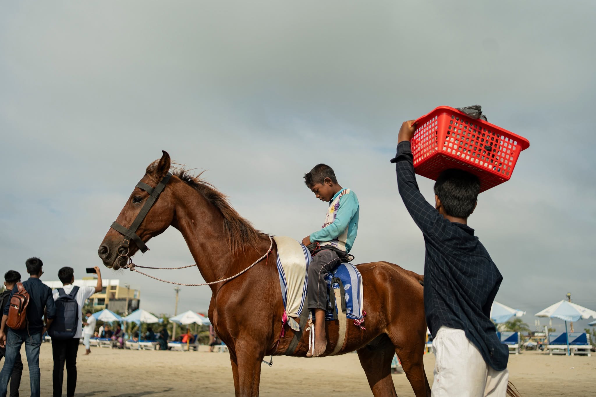 Boy on horseback along a sandy beach