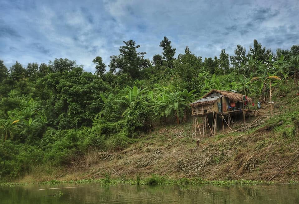 Traditional stilt house overlooking a river in the hills