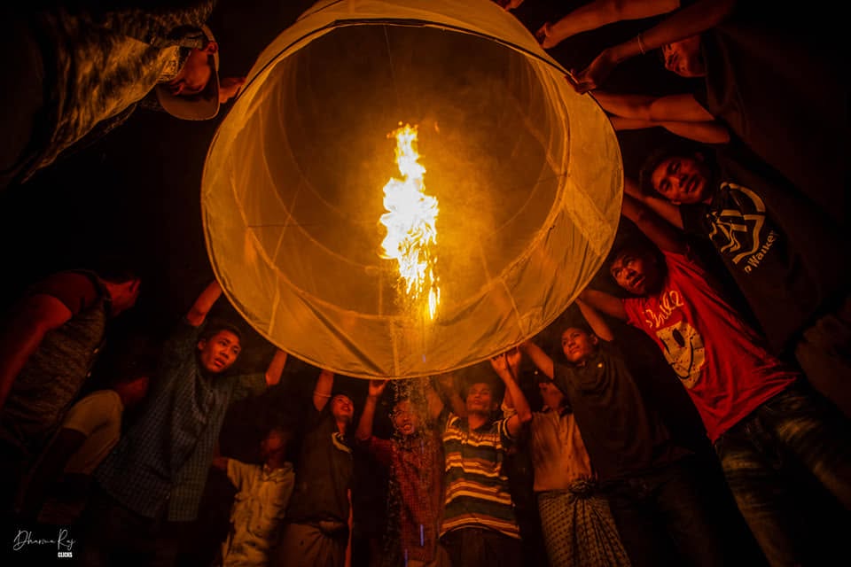 Community releasing a sky lantern at night